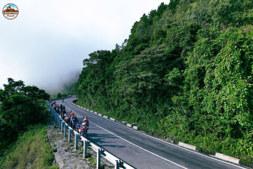 Cloud-covered Hai Van Pass coastal mountain road with panoramic sea views in Central Vietnam.